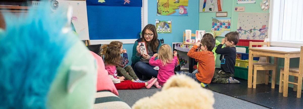 woman teaching children