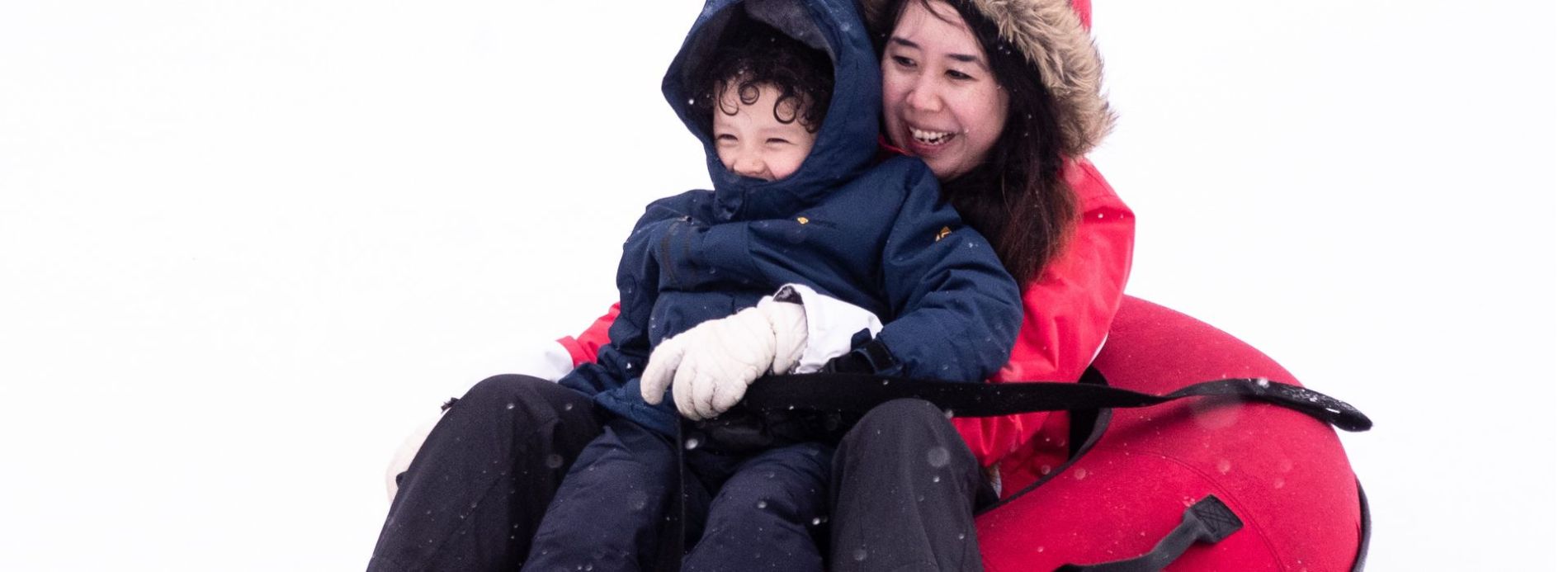 mother and child snow tubing