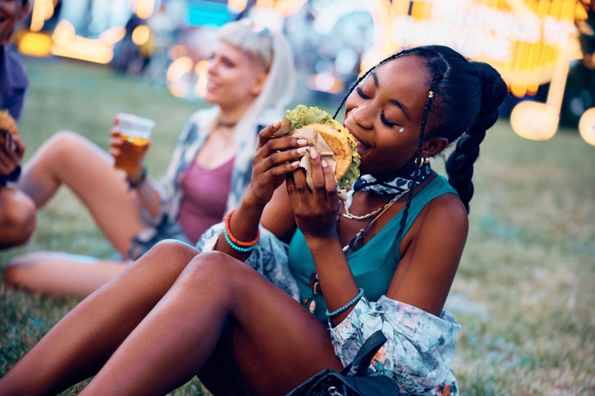 girl eating burger at music festival